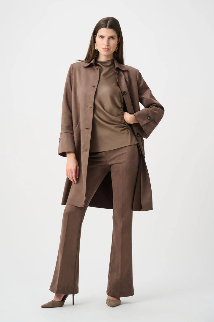 A full length shot of women striking a pose wearing the Joseph Ribkoff Faux Suede Car Coat, unbuttoned with her hand on her hip.