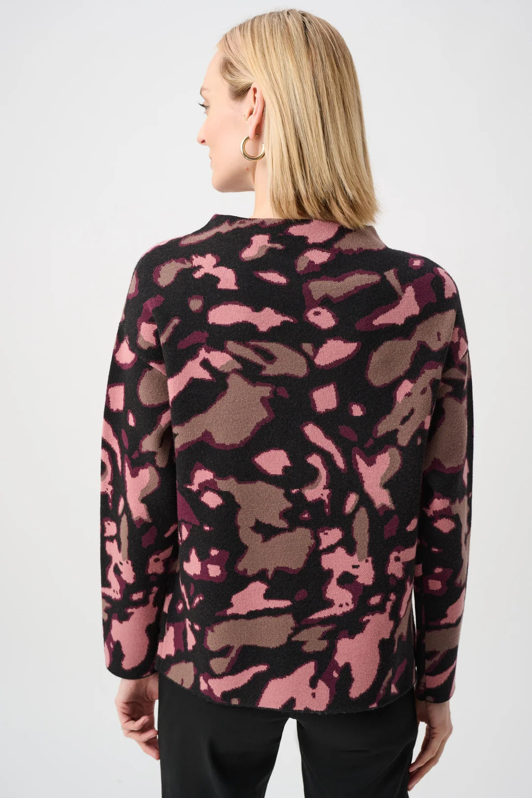 View from behind of a woman wearing the Joseph Ribkoff Abstract Print Sweater Style 263930 showcasing it's abstract print and rhinestone accents.
