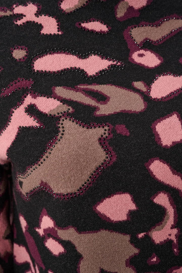Close-up of the pink and brown abstract shapes and rhinestone accents on a black background on the Joseph Ribkoff Abstract Print Sweater Style 263930.