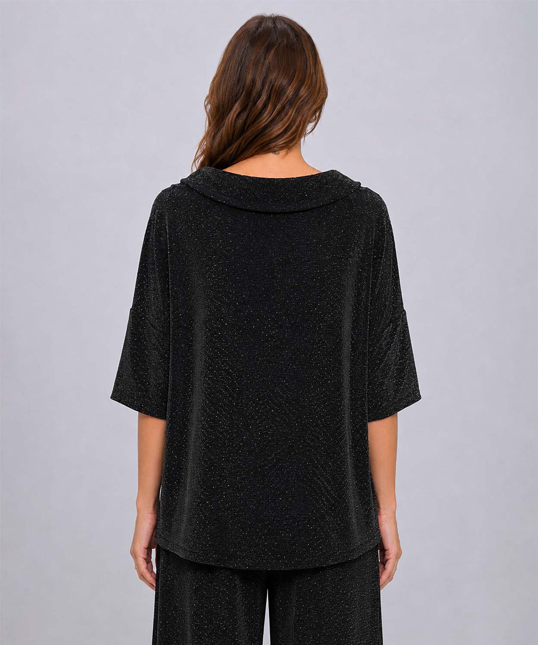 A view from behind of the black Last Tango Glitter High-Low Top in front of a grey studio background