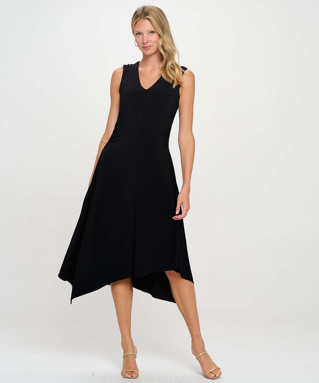 A woman wearing a black Last Tango Asymmetrical Sleeveless V Neck Dress with Side Ruching in-front of a white studio background.