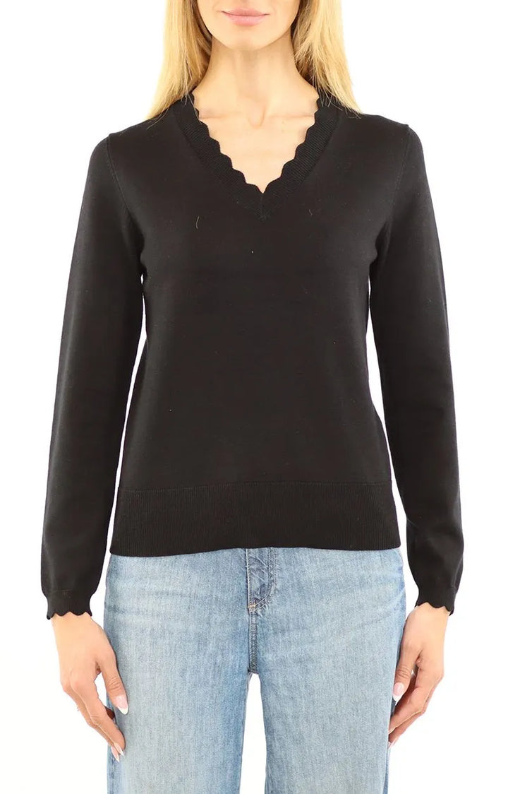 Metric Knits Scalloped Neck Long Sleeve Pullover in black styled with blue jeans.